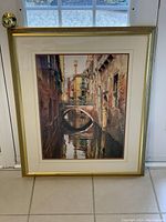 Front view of the framed art print showing the canal, bridge, buildings, and water reflection.