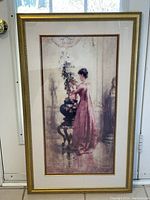Frontal view of the framed art print showing a Victorian lady arranging flowers in a detailed gold-toned frame.