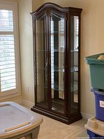 Front view of entire cabinet showing closed glass doors and overall shape