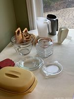 Photo showing all items including glass storage, Tupperware vegetable dish, candy jar, coasters, milk holders and wooden napkin holder.