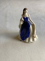 Front view of the Royal Doulton Pretty Ladies Loved One figurine in blue dress.