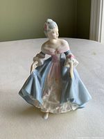 Front view of Royal Doulton Southern Belle figurine, showing detailed dress and painted features