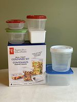 Photo of assorted plastic storage containers along with a boxed 4-piece President's Choice seal-tight container set.