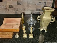Full lot grouped on counter, showing brass vase, microscope wooden box, incense burner, Buddha, candle sticks, and small boxes.
