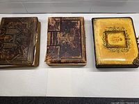 Front view of the three photo albums showing cover details and condition.