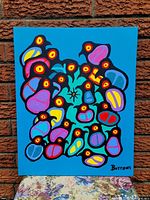 Front view of acrylic painting on stretched canvas leaning against brick wall