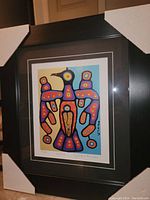 Framed colorful Thunderbird print by Christian Morrisseau, showing full artwork and frame with protective corners.