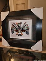 Full frontal view of the professionally framed Chief Henry Speck print "Thunderbird" in black frame with corner protectors.