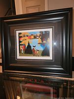 Framed Maud Lewis fine art print showing colorful deer at lake scene