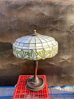 Full front view of lamp on red crate against black backdrop