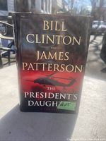 Front cover of The President's Daughter book showing authors' names and title with helicopter image on dust jacket.