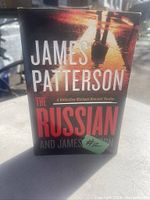 Front cover of the 2022 hardcover book titled 'The Russian' by James Patterson and James O. Born showing the authors' names and book title with a shadowed figure background.