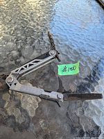 Gerber USA multi-tool open with visible knife blade and file tool extended on glass surface.