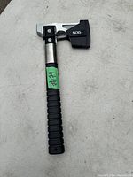 View of SOG Camp Axe standing upright showing full handle and head with blade cover attached.