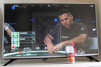 Front view of LG 42 inch flat screen TV displaying a televised poker game with clear image quality and no visible damage.