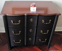 Front view of Drexel Heritage night stand showing scalloped wood top and three drawers with brass handles and escutcheons.