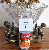 Front angle showing full compote bowl with etched lead crystal design and brass base with three cherubs.