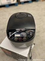 Front view of black and silver Ecohouzng multifunction cooker with digital LED display showing controls and buttons.