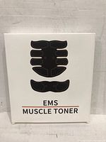 Front of box showing EMS Muscle Toner kit and outline of muscle stimulator pads.