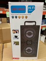 Front view of box showing JBK-8839 black Hi-Fi speaker with dual speaker cones and carrying handle.