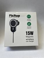 Front of product box showing PitStop Electronics branding, features including 15W wireless charging and powerful magnet.