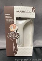 Boxed TouchBeauty AS-0888 face massage roller with product branding and model details visible.