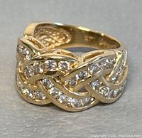 Three-quarter view showing braided pave design and band width