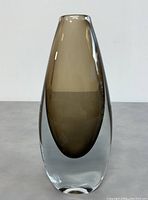 Front view of elongated Swedish Sommerso glass vase with brown inner layer encased in clear glass.
