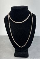 Two sterling silver 925 necklaces displayed on black necklace stand, showing 24-inch and 16-inch lengths.