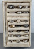 Tray view of 21 rings laid in foam display