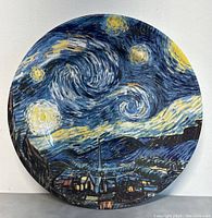 Front view of the round decorative plate featuring Van Gogh's Starry Night print with vibrant blues and yellows and visible gloss.