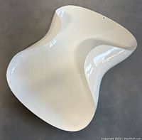 Top view showing the fluid, curved design of the white basket.