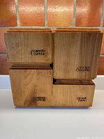 Photo of all four wooden canisters stacked together, showing front labels Café/Coffee, Sucre/Sugar, Farine/Flour, and Thé/Tea