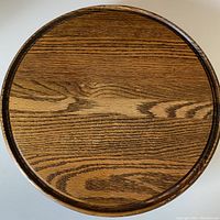 Top view of the large round oak Lazy Susan showing the wood grain and routed edge.