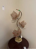 Full front view showing base and three pink glass lotus shades