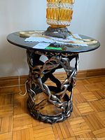 Full view of the vintage side table showing the smoked glass top and twisted composite plastic frame base in a bronze finish.