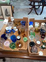 Box of assorted miniature glass and ceramic vases and figurines with varied colors and shapes including blue, green, amber, clear glass and painted ceramics
