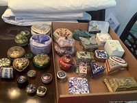 Top-down view of all vanity and trinket boxes on table