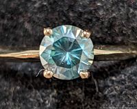 Top view showing round brilliant moissanite held by four prongs