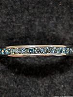 Front view of ring showing continuous row of channel-set diamonds