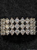 Close-up front view showing the arrangement of cubic zirconia stones in a lattice pattern on a sterling silver band.