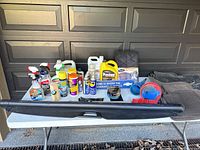 Full view of all items laid out on white table in front of garage door.