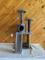 Full front view of gray cat tree showing perches, nest cubby, scratching posts and ramp.