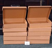 Stack of 10 brown cardboard shipping boxes with lids open, showing interior and size