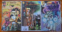 Three Katmandu comic books including issues 13, 14 and 15, showing colorful covers with anthropomorphic characters.