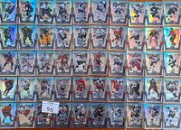 Overview of 50 hockey cards laid out in rows showing front faces with player images and names, holographic finish visible.
