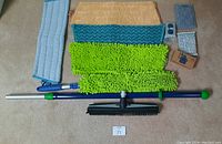 Full lot arranged on carpet showing all cleaning tools, scrubbers, sponges, cloths and mop pads