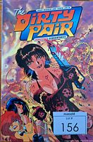 Front cover of The Dirty Pair: Dangerous Acquaintances graphic novel showing colorful artwork with two female characters, one holding a gun.