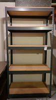 Front view of the metal and wood industrial shelf with five tiers.