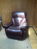 Front view of dark brown leather swivel rocker recliner